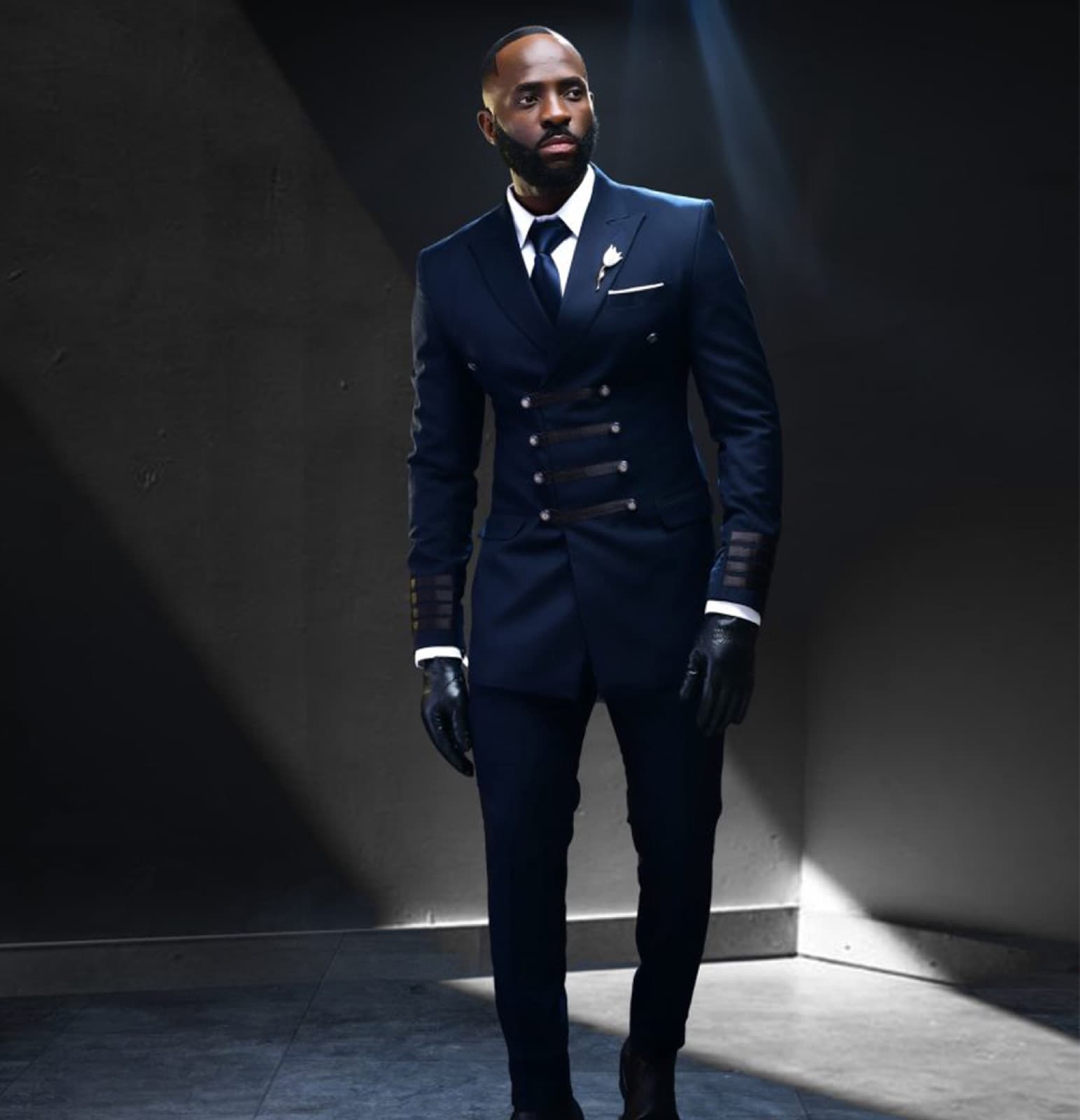 Navy double-breasted suit with military-inspired detailing.