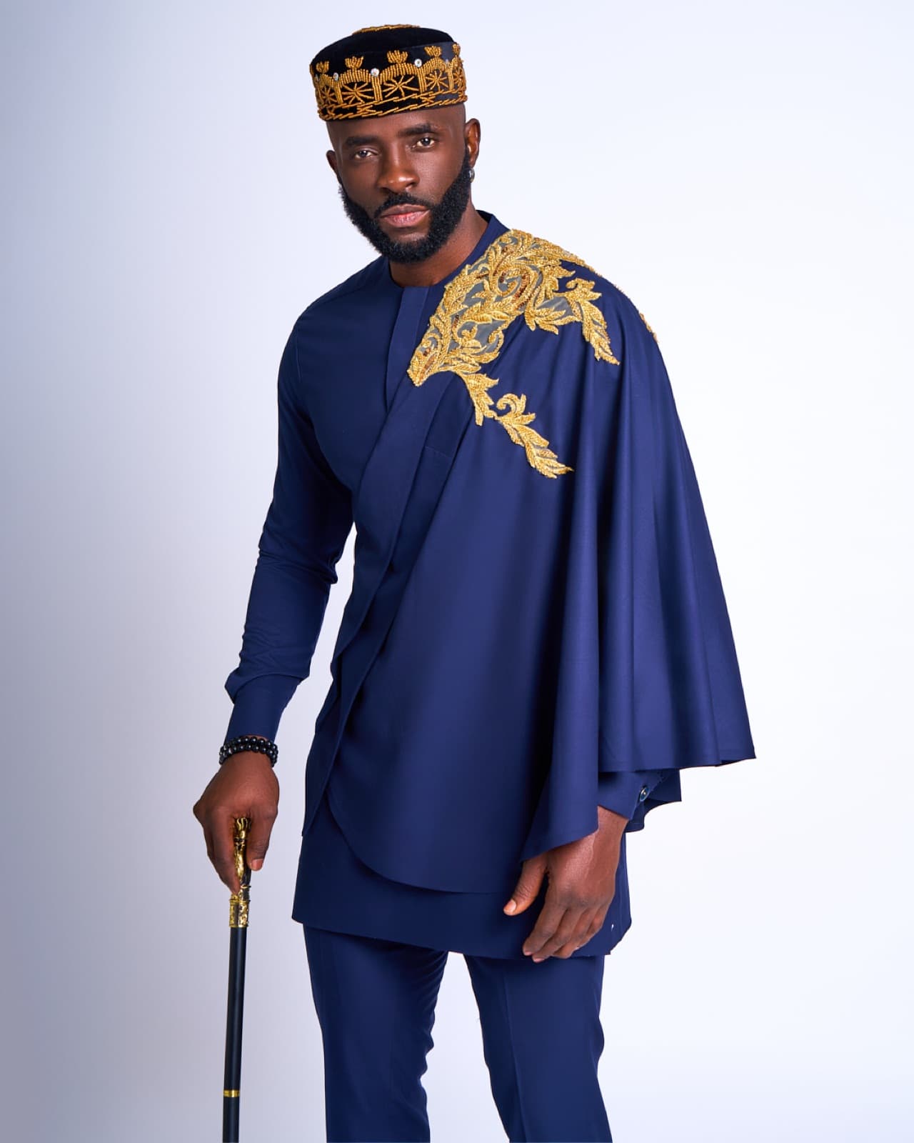 Navy kaftan with gold shoulder embroidery.